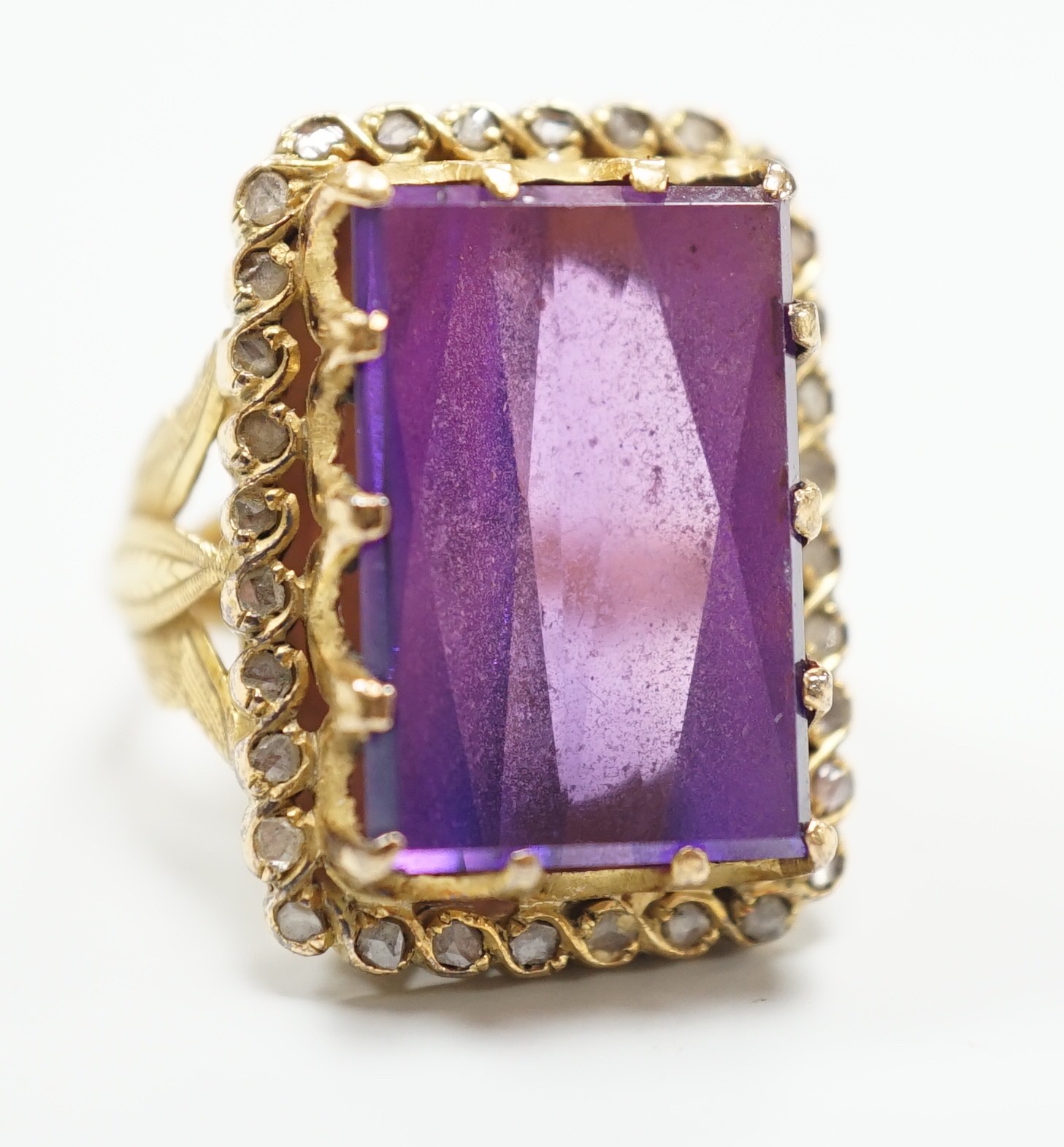 A Portuguese? yellow metal (stamped 800) and rectangular cut synthetic colour change corundum set dress ring, with diamond chip set border, size M, gross weight 13 grams.